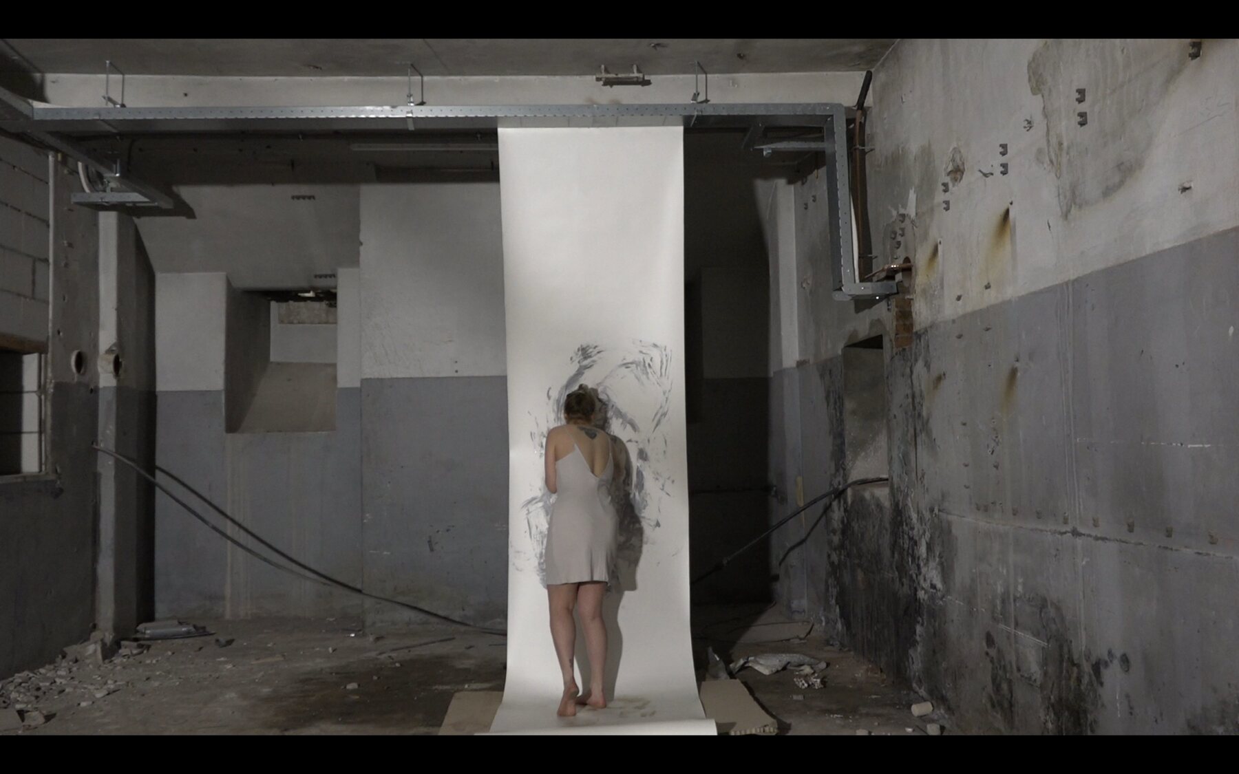 A wide view of a body standing close to the marked suspended surface
