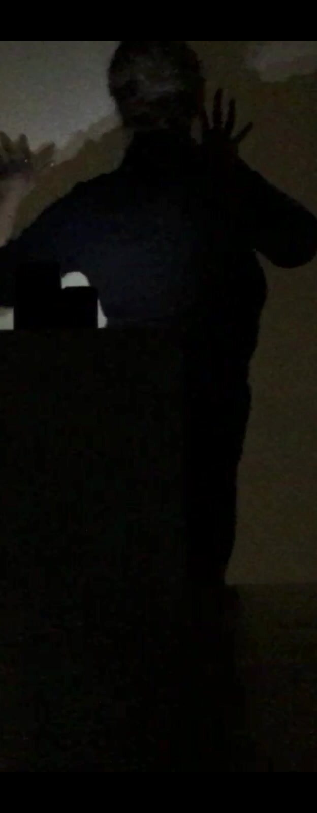 A dark silhouette held inside a field of diffused light